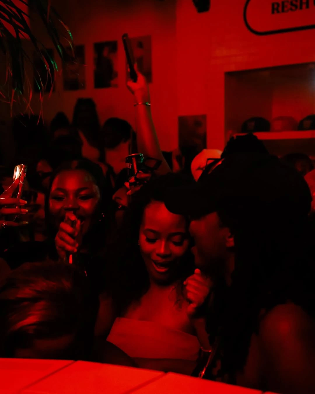 Energetic crowd dancing to Amapiano at Night in Lagos rooftop party in Cape Town